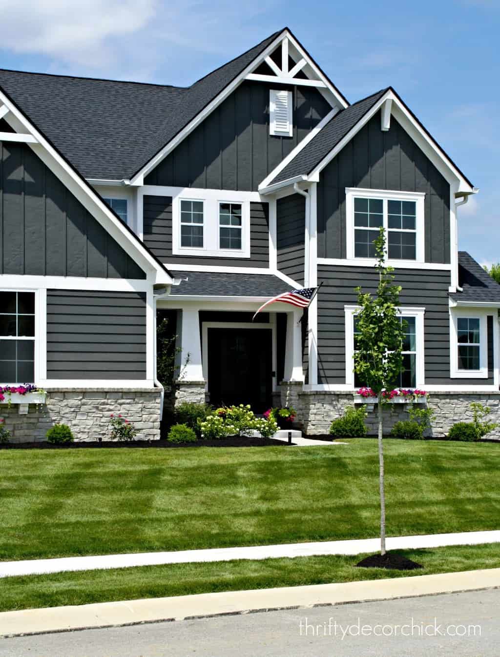 grey siding house with black roof Shin Mcclellan